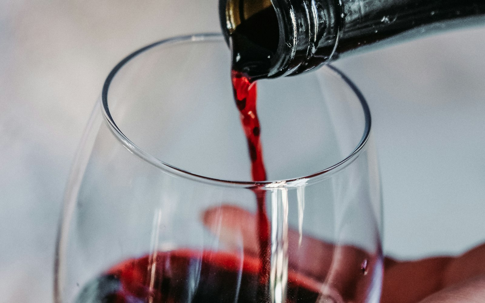 Wine being poured into a tulip glass