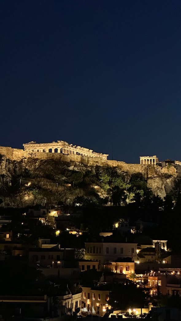 The lit Acropolis at night, seen from the Thea Terrace Bar at Central Hotel during the ENOAVE tasting event in Athens